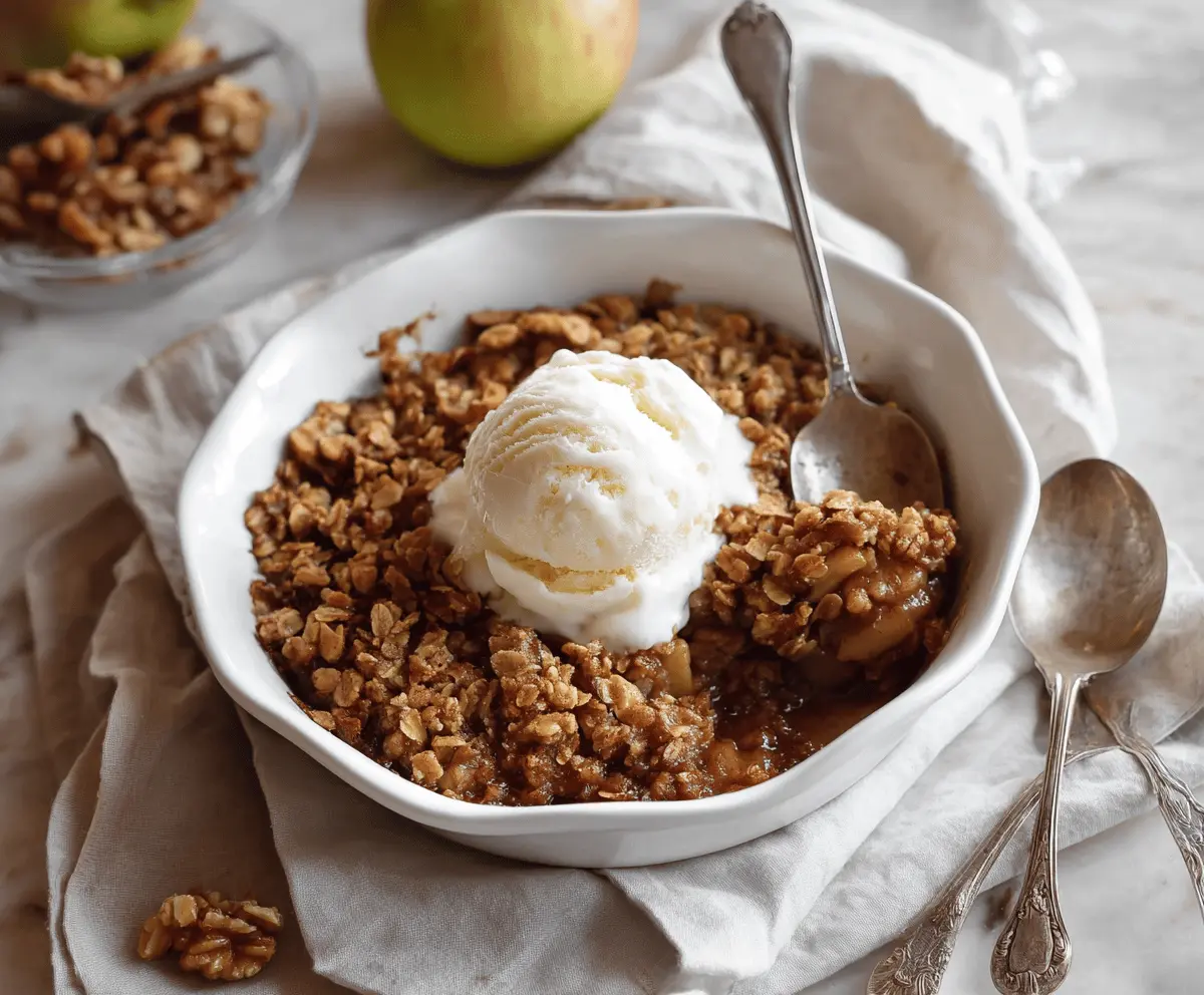 Delicious Maple Walnut Apple Crisp topped with golden brown crust and crunchy walnuts, served in a bowl on a rustic wooden table
