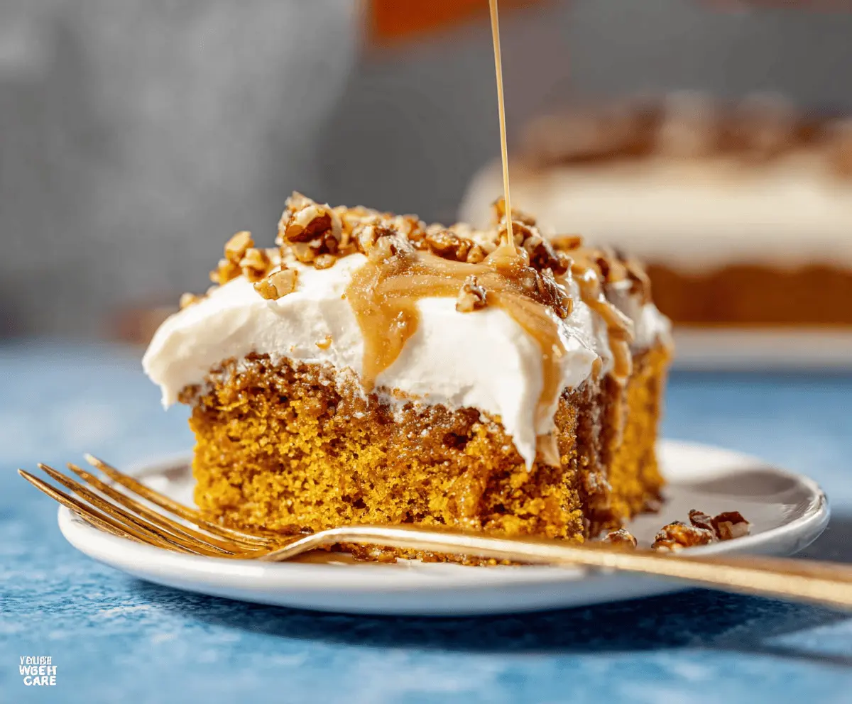 Delicious Pumpkin Poke Cake topped with whipped cream and sprinkles, perfect for fall desserts.