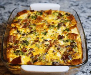 Delicious egg breakfast casserole with cheese and vegetables in a baking dish.