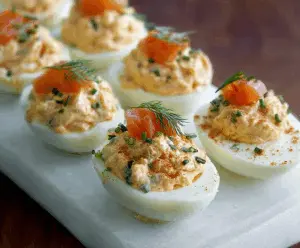 Delicious smoked salmon stuffed eggs garnished with fresh herbs for a tasty appetizer