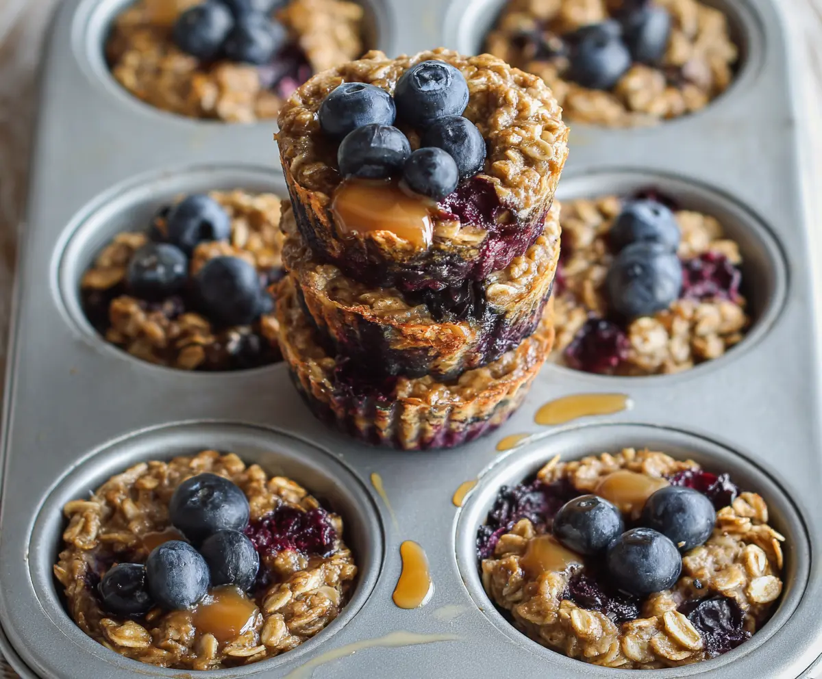 Healthy blueberry banana baked oatmeal cups in a muffin tin for a nutritious breakfast.