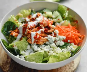 Creamy Buffalo Chicken Salad with fresh greens and blue cheese crumbles, perfect for a flavorful lunch or dinner.