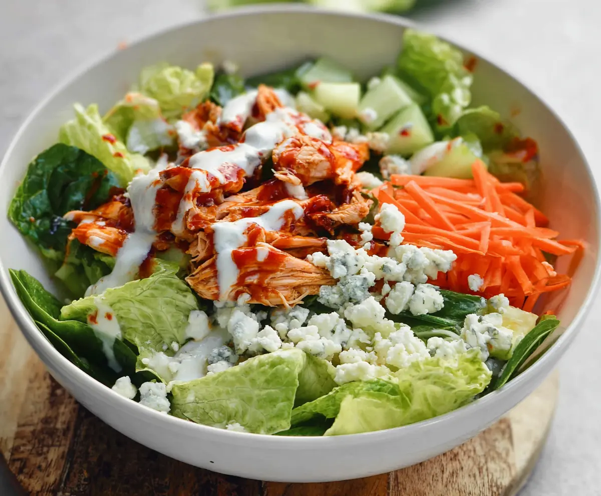 Creamy Buffalo Chicken Salad with fresh greens and blue cheese crumbles, perfect for a flavorful lunch or dinner.