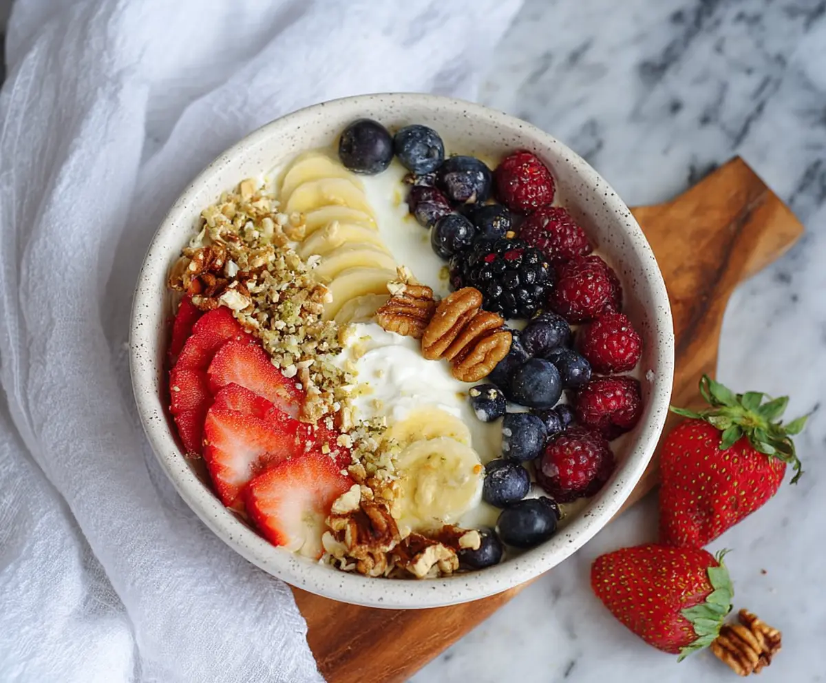 Healthy Greek Yogurt Protein Bowl topped with fresh berries and nuts for a nutritious breakfast.