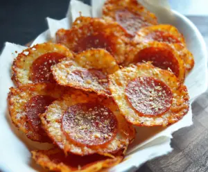 Crispy Pepperoni and Cheese Chips on a plate with melted cheese and savory pepperoni slices.