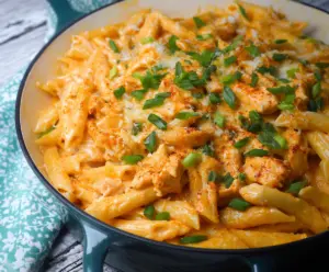 Creamy Buffalo Chicken Alfredo Penne pasta dish with spicy sauce and grilled chicken pieces