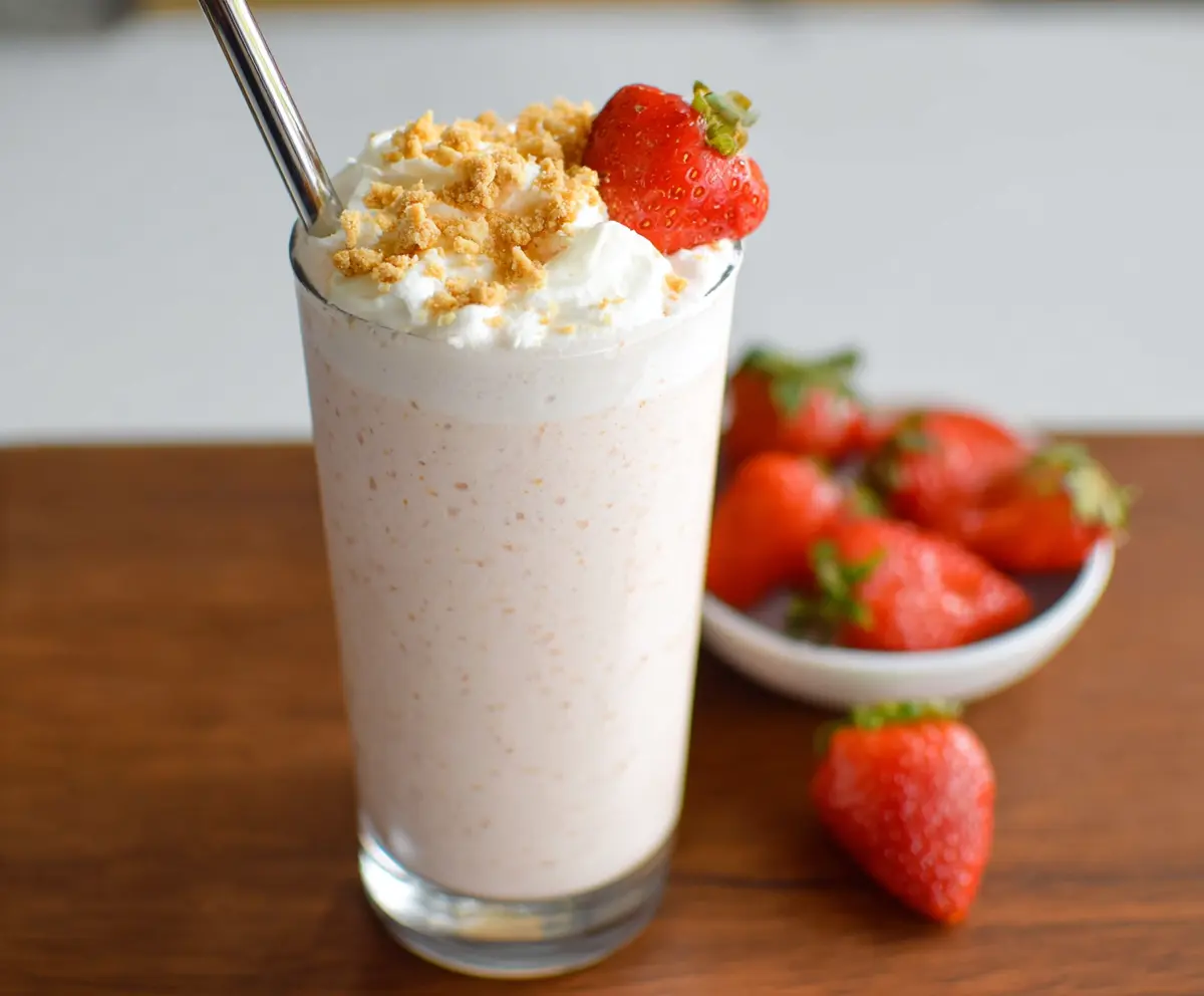 Delicious cottage cheese shake in a glass topped with fresh fruit and mint, perfect for a healthy snack.