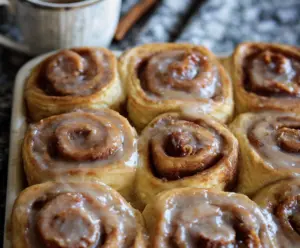 Delicious homemade sourdough apple cider cinnamon rolls topped with icing.