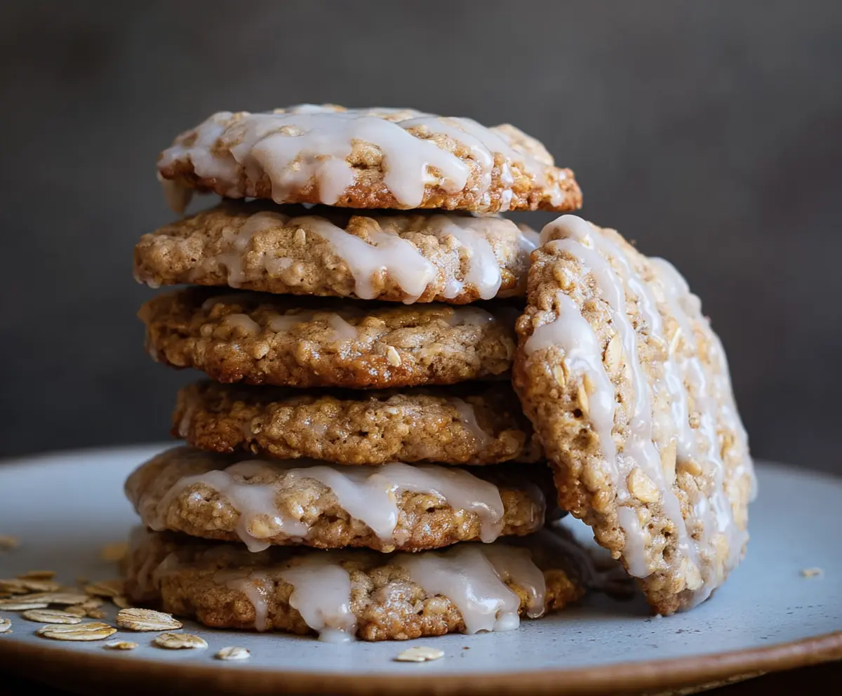 Delicious sourdough discard glazed oatmeal cookies on a plate, showcasing crispy edges and a shiny glaze.
