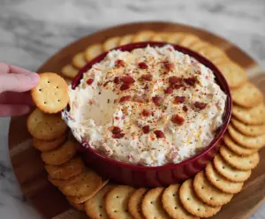 Creamy Alabama Fire Cracker Dip served with fresh vegetables and chips for dipping at a party.