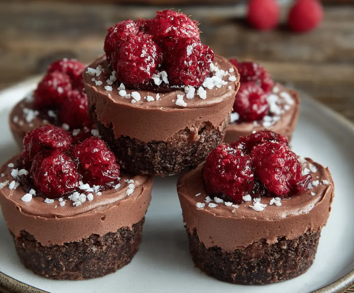 Delicious Marry Me Raspberry Chocolate Mousse Cups topped with fresh raspberries and chocolate shavings.