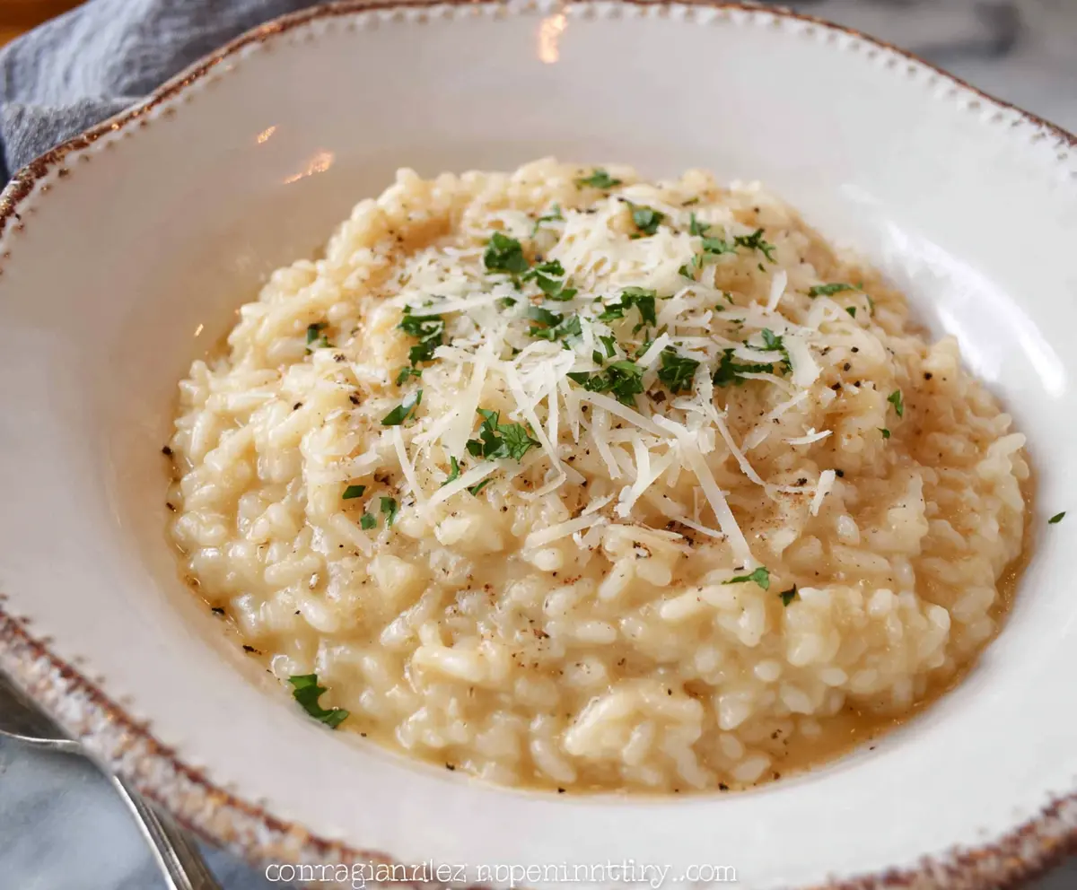 Creamy Parmesan Risotto in a bowl, garnished with fresh herbs for a flavorful Italian dish.