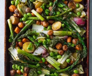 Colorful sheet pan spring vegetables with asparagus, carrots, and snap peas roasted to perfection.