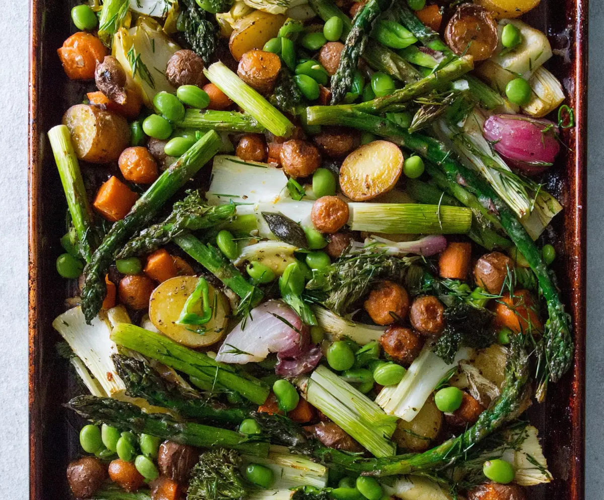 Colorful sheet pan spring vegetables with asparagus, carrots, and snap peas roasted to perfection.