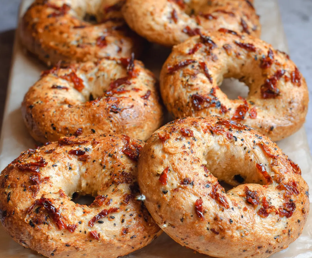 Delicious Sun-Dried Tomato Sourdough Bagels fresh out of the oven with a golden crust.