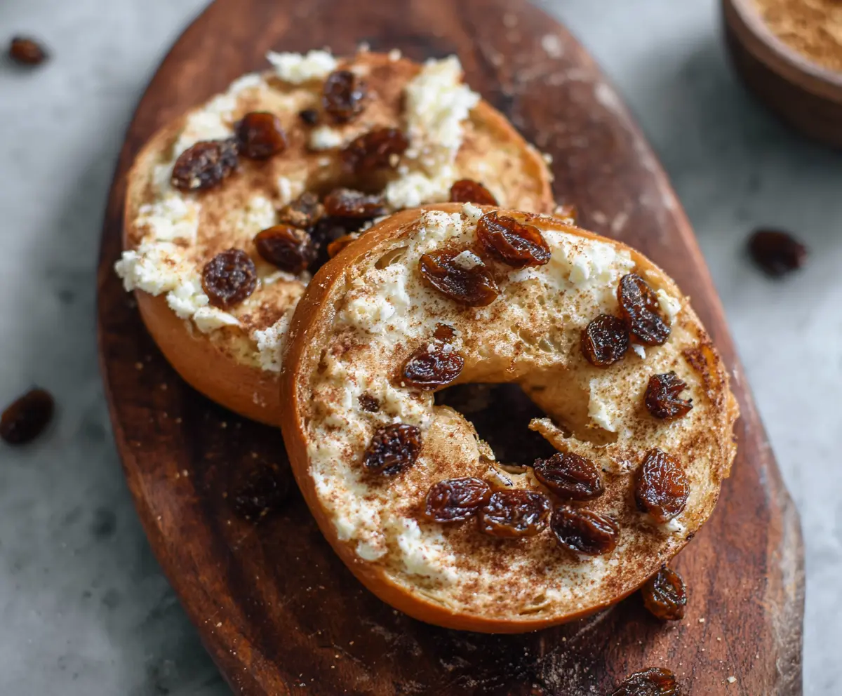 Delicious 5-ingredient cinnamon raisin Greek yogurt bagels on a wooden surface.