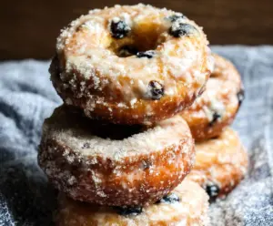 Delicious homemade blueberry cake donuts with vibrant blueberries on top.
