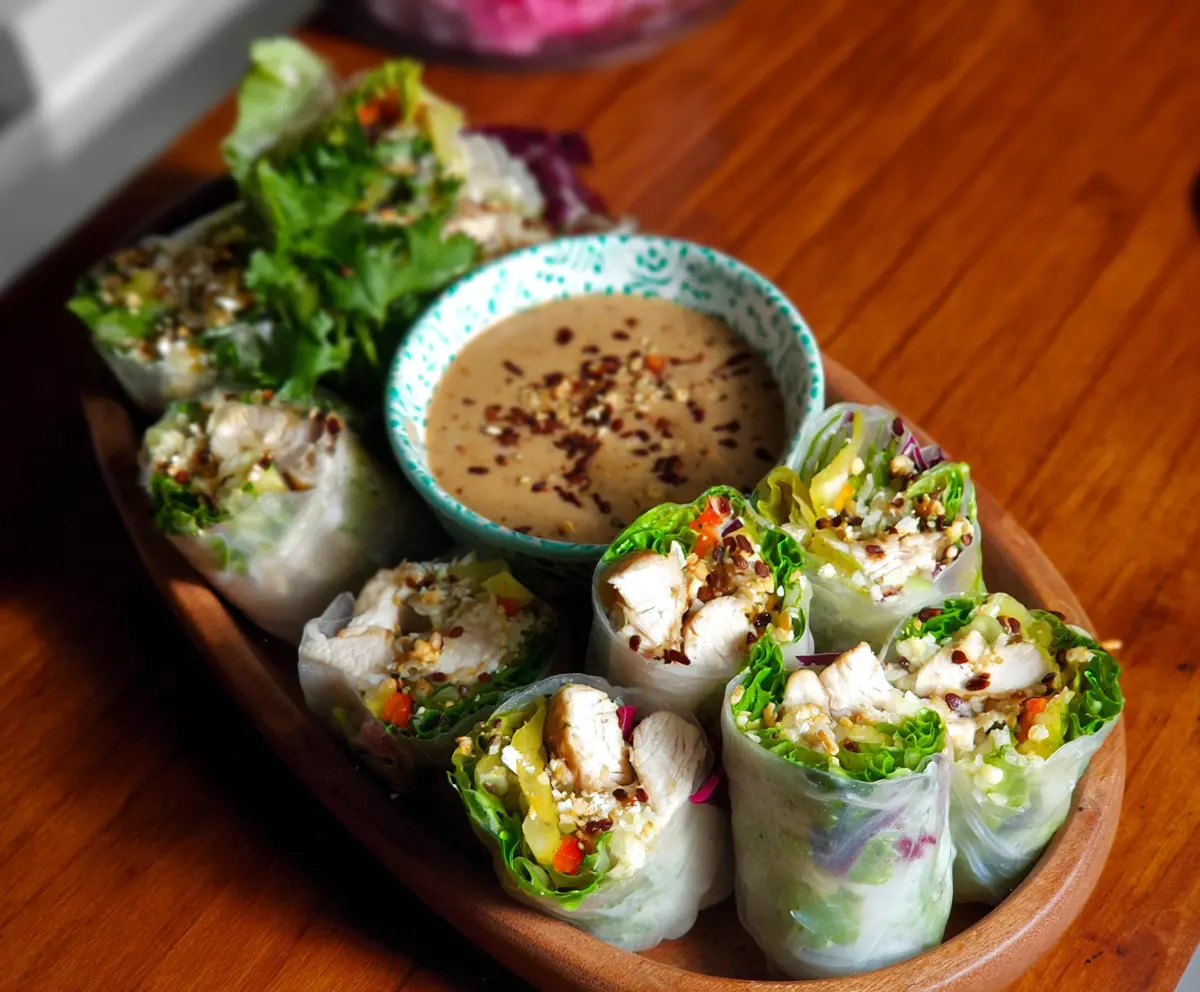 Delicious Caesar Chicken Rice Paper Rolls with crispy vegetables and creamy dressing
