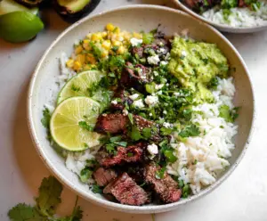Delicious Cilantro Lime Steak and Rice Bowls served in a bowl highlighting fresh herbs and grilled steak