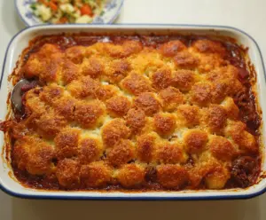 Delicious Corned Beef Casserole topped with melted cheese and fresh herbs