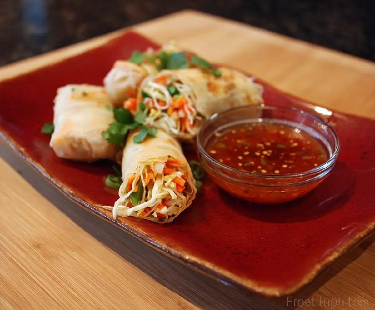 Crispy Lo Mein spring rolls filled with noodles and vegetables served with dipping sauce