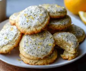 Fresh Lemon Poppy Seed Cookies on a white plate, showcasing golden crust and poppy seeds.